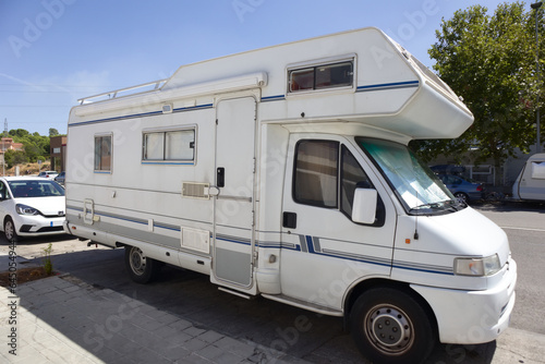 A motorhome parked on a street during a break from the trip to summer vacation