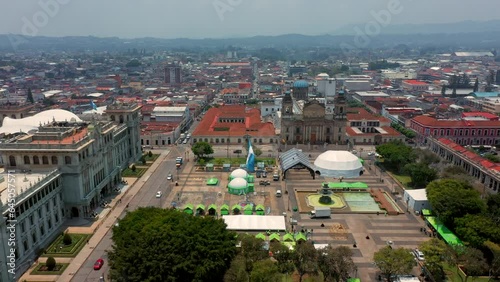 Vista aérea de la plaza central de ciudad de Guatemala bandera guatemalteca ondeando con el  viento catedral y palacio de cultura photo