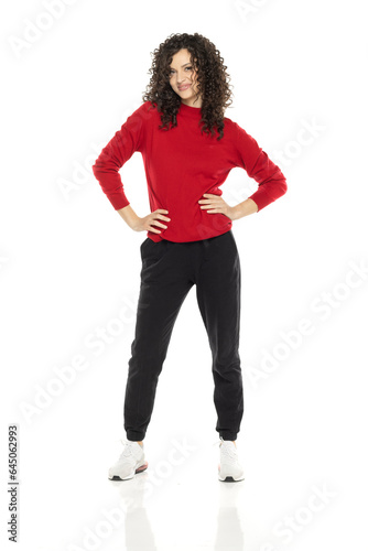Young curly happy woman posing on white background.
