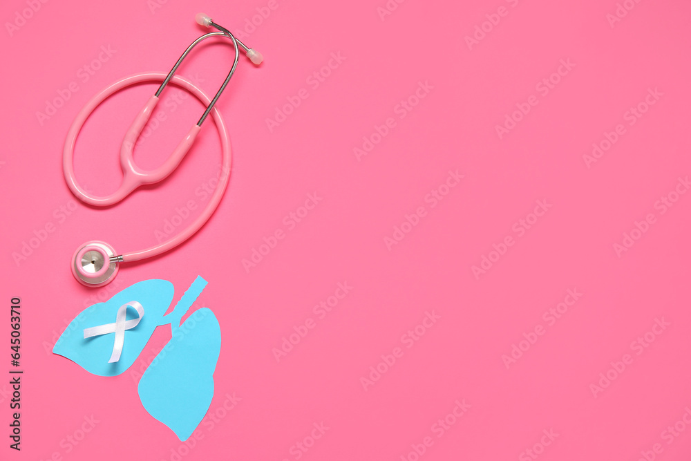 Paper lungs, stethoscope and white ribbon on pink background. Lung cancer concept