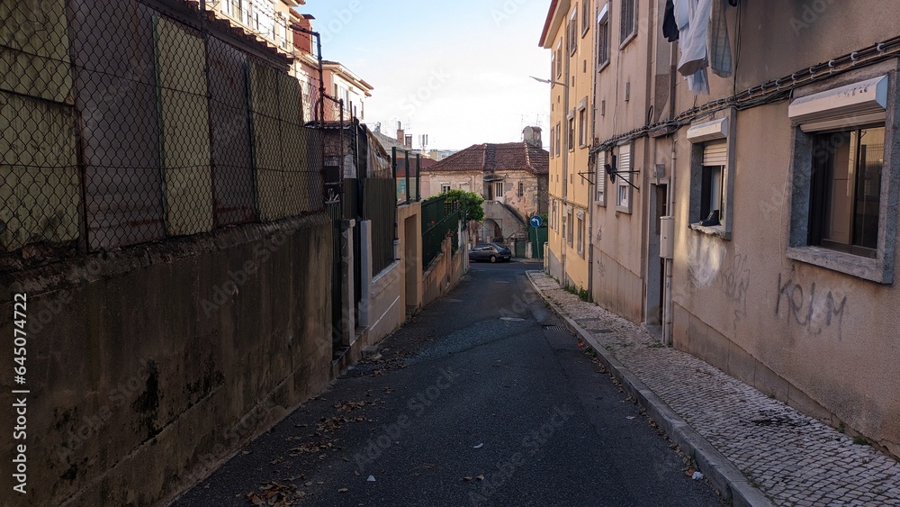A narrow street early in the morning in Lisbon without people