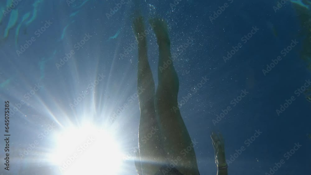 The boy floats on top of the camera lying at the bottom of the pool The boy floats on top of the camera lying at the bottom of the pool