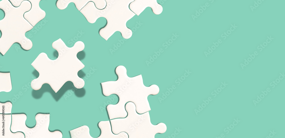 White jigsaw puzzle on green background, Find the right joined team and fit correctly concept, space for writing copy White jigsaw puzzle on green background, Find the right joined team and fit correctly concept, space for writing copy