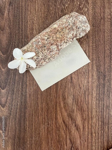 Business card on a wooden table. Card in the interior with flowers
