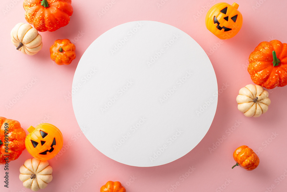 Modernized Halloween themed layout. Top view capturing thematic elements: small carved pumpkins on pastel pink background. Empty circle for greetings or advertisements Modernized Halloween themed layout. Top view capturing thematic elements: small carved pumpkins on pastel pink background. Empty circle for greetings or advertisements