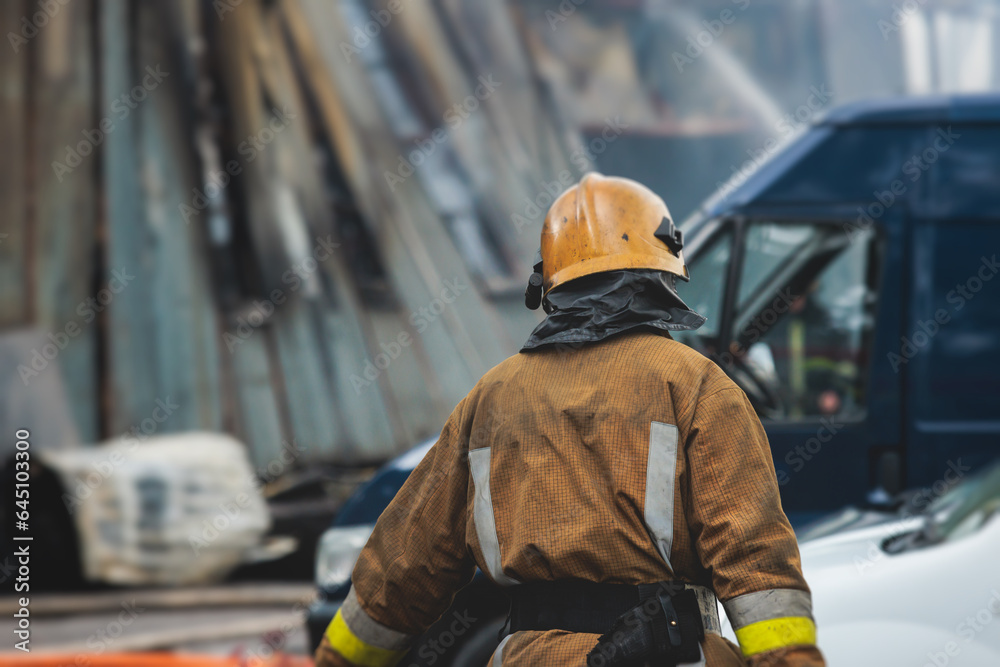 Group of fire men in protective uniform during fire fighting operation in the city streets, firefighters brigade with the fire engine truck vehicle in the background, emergency and rescue service Group of fire men in protective uniform during fire fighting operation in the city streets, firefighters brigade with the fire engine truck vehicle in the background, emergency and rescue service