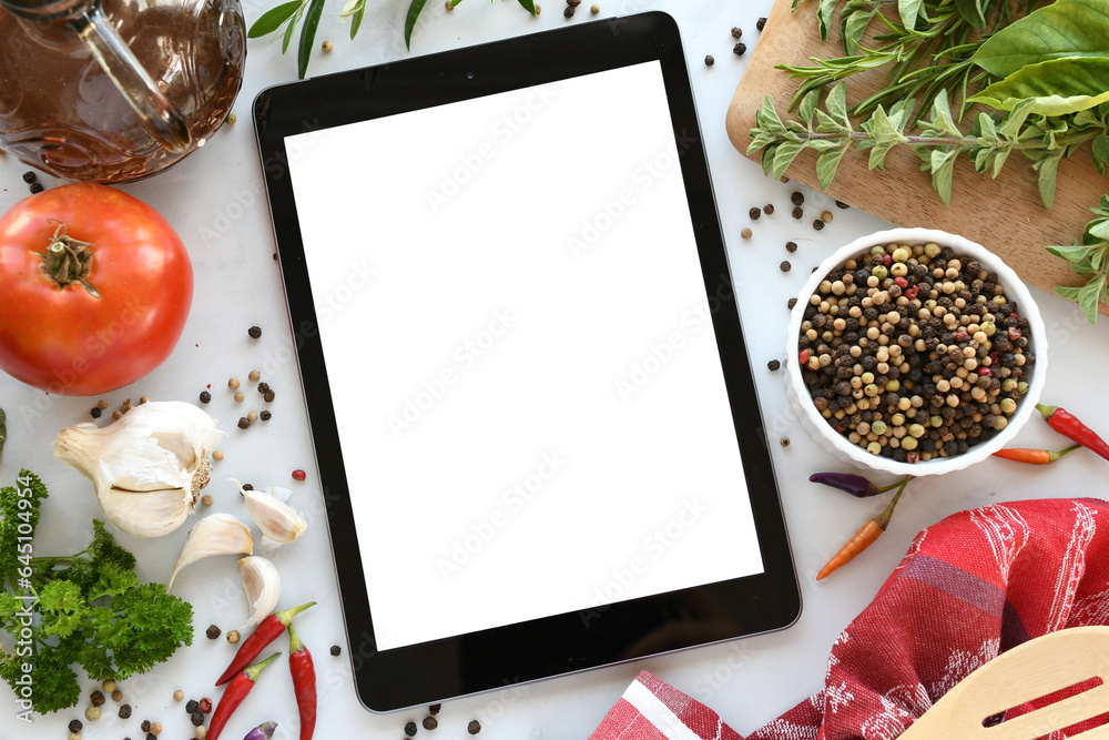 Tablet computer with mock up white screen in kitchen with food flat lay background. Online grocery shopping, takeout, food delivery app ads or recipe concept. - obrazy, fototapety, plakaty 