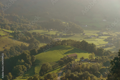 Beautiful basque countryside with green hills in golden sunlight at the spanish french border near Beartzun, Navarre, Spain