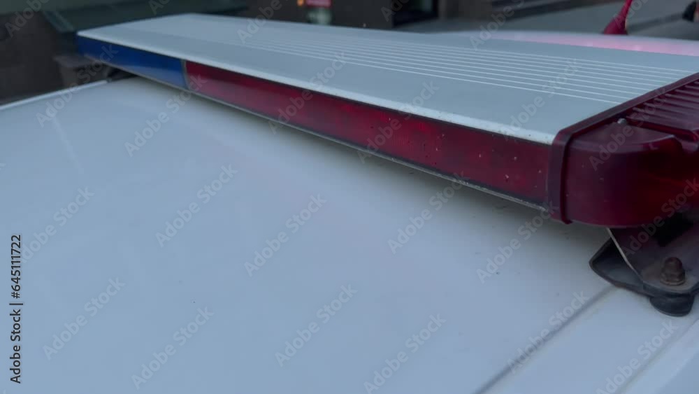 Close up of a police car with red and blue flashing lights. Closeup of