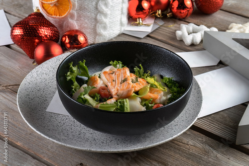 Salmon steak, calamari, shrimp with salad for New Year's table. New Year's decoration, beautiful table. Side view, macro