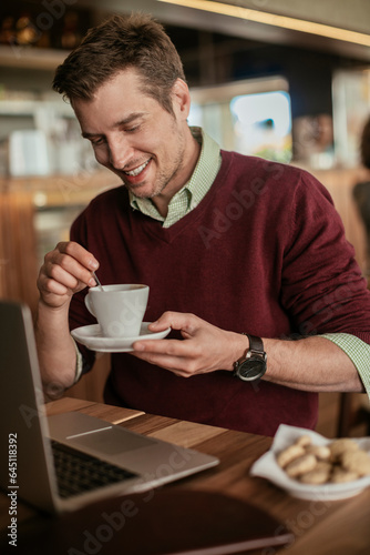 Young man enjoying a cup of coffee in a cafe