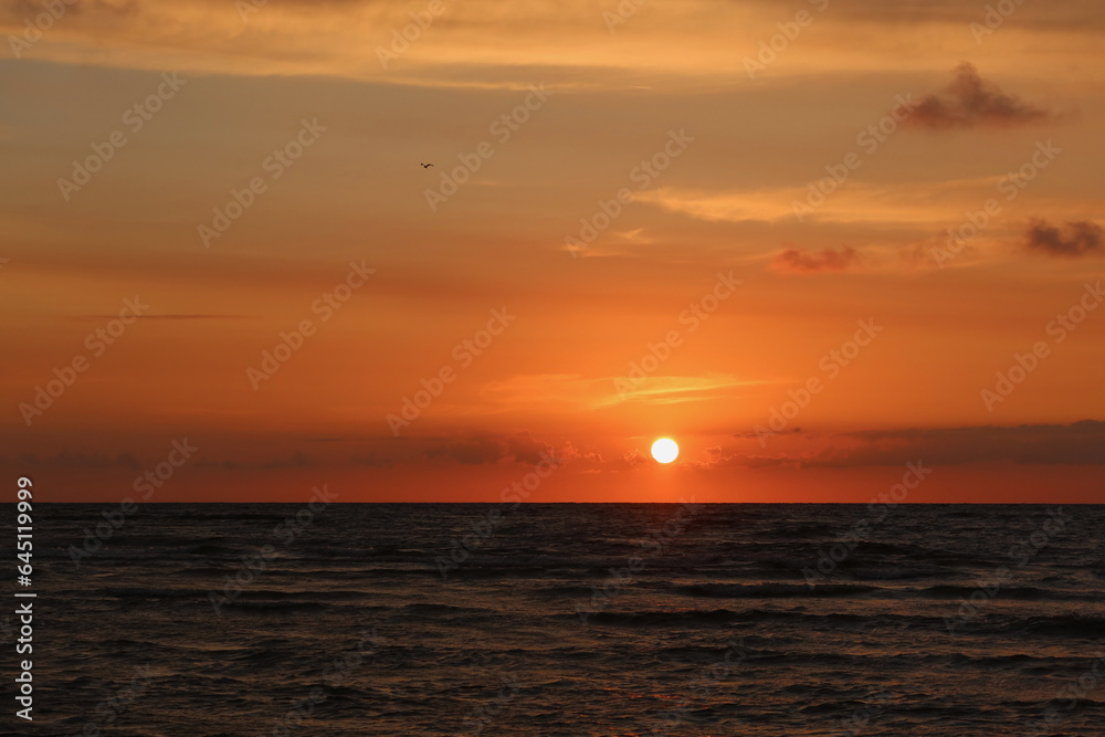 Scenic sunset over the sea. Calm Baltic sea. Poland seaside, Leba village and beach. Seascape