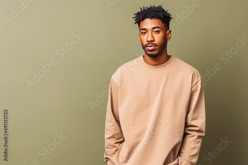Portrait of handsome african american male looking serious in casual clothes on a colored background
