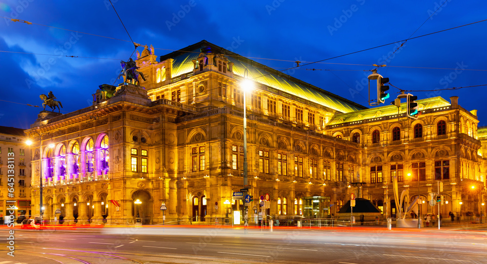 Scenic view of Vienna cityscape overlooking central avenue and neo-Renaissance building of State Opera with evening illumination in winter, Austria.