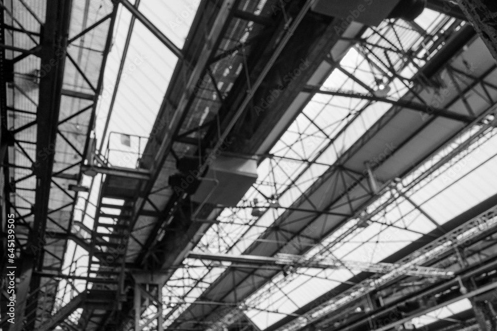 Black and white tone, Defocus and low angle interior view of the ceiling with steel structure and skylight of industrial building or factory. 