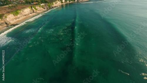 Surfers waiting for a wave in Bali — FPV drone aerial view