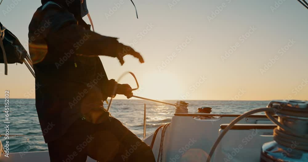 Sunset, boat and man pull anchor at ocean to travel, vacation or holiday outdoor. Tighten rope, sailing and person on ship, yacht and sailor cruise at sea in transportation on journey on mockup space