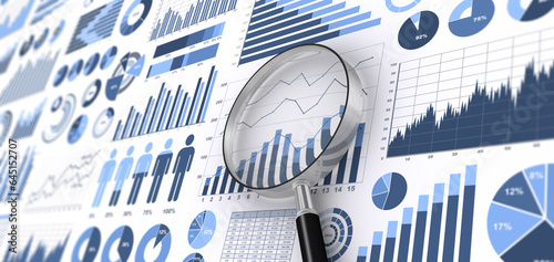 様々なグラフやチャートと虫メガネ、ビジネスデータを分析・検討するイメージ photo