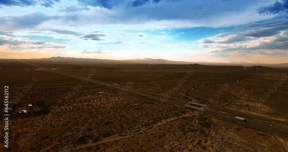 Traffic on the highways of Nevada valley. Transport moving by the roads in the dry desert. Aerial view. Traffic on the highways of Nevada valley. Transport moving by the roads in the dry desert. Aerial view.
