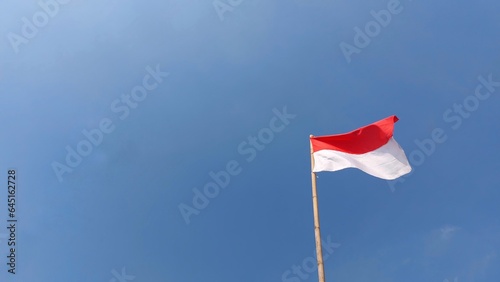 Indonesian flag. Red and white flag. In blue sky