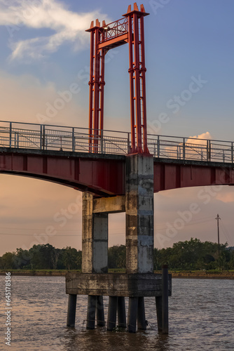 Kumala Island Red Bridge which is access to one of the tourist destinations in Tenggarong City, Kutai Kartanegara Regency, namely Kumala Island. photo