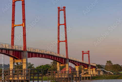 Kumala Island Red Bridge which is access to one of the tourist destinations in Tenggarong City, Kutai Kartanegara Regency, namely Kumala Island. photo
