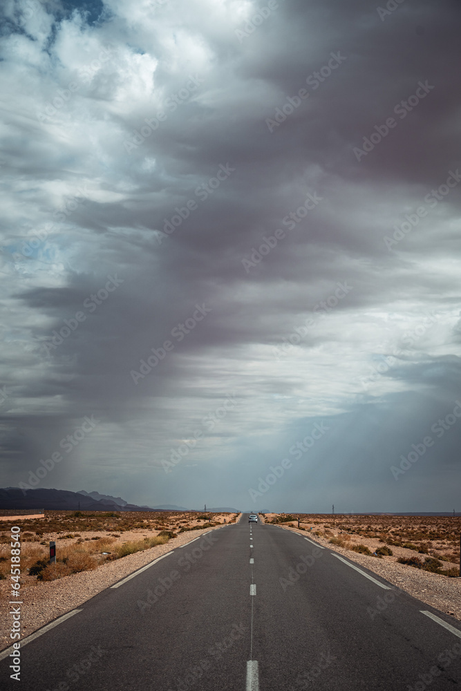 Lonely road with extreme weather in Morocco close to Merzouga, Sahara Desert