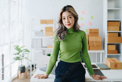 Portrait Of Asian Female Owner Of Fashion Store Clothing Store successful happy smile at small business, sme or ecommerce concepts © Jirapong