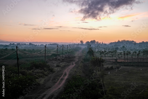 sunrise over the dirt road, sunrise at a village, sunrise over the field, view of the sunrise in a village in Lombok