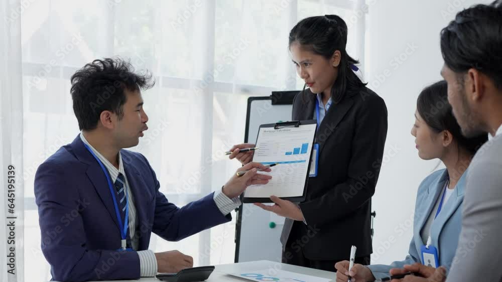 Teamwork of a group of business people discussing, brainstorming and calculating on assessment data in a meeting room. Focus on business growth and point to financial accounting chart. Teamwork of a group of business people discussing, brainstorming and calculating on assessment data in a meeting room. Focus on business growth and point to financial accounting chart.