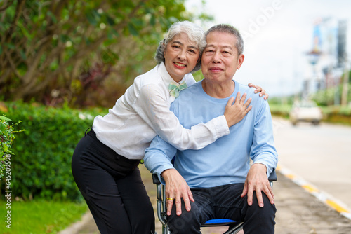 Nature harmony, Asian elderly couple happiness in the outdoor park, Elderly husband on wheelchair, wife caregiving, park outdoor, happy family, grey hair, hug, kiss © makibestphoto