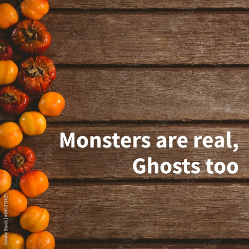 Composite of monsters are real, ghosts too text and halloween pumpkins on wooden background