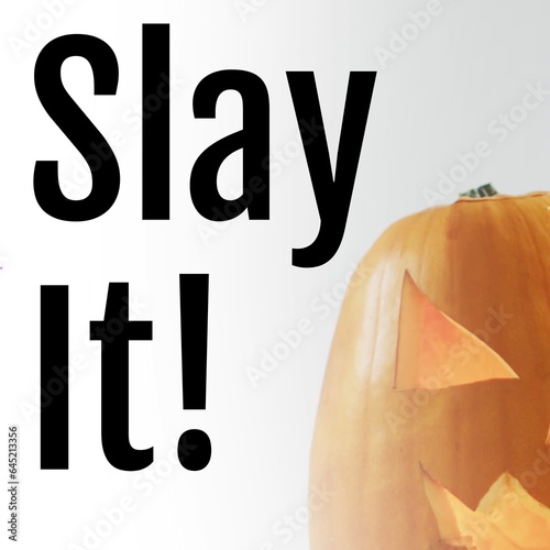 Composite of slay it text and carved halloween pumpkin on white background
