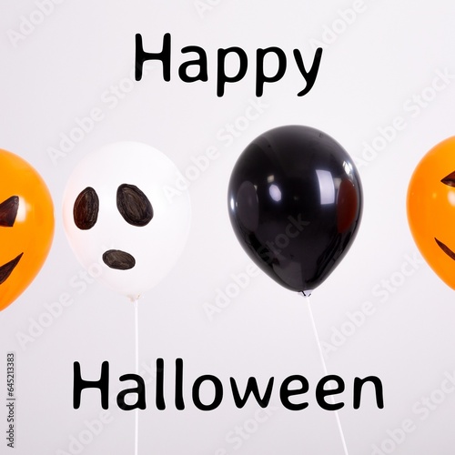 Composite of happy halloween text and halloween balloons on white background