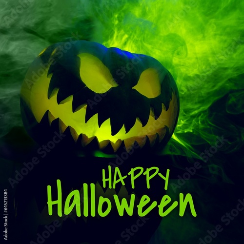 Composite of happy halloween text and halloween pumpkin on green background