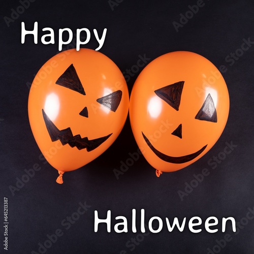 Composite of happy halloween text and halloween pumpkin balloons on black background