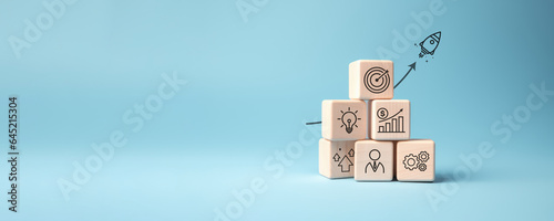 Rocket launching from wood cube with business icon, Start-up, Creativity, Big idea, Business goals management, Investment on new project to wealth, Company strategy target, Sustainable financial plan