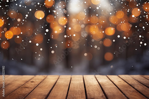 Beautiful winter snowy blurred defocused gold background and empty wooden flooring. Flakes of snow fall and sparkle on light, copy space. © Robert