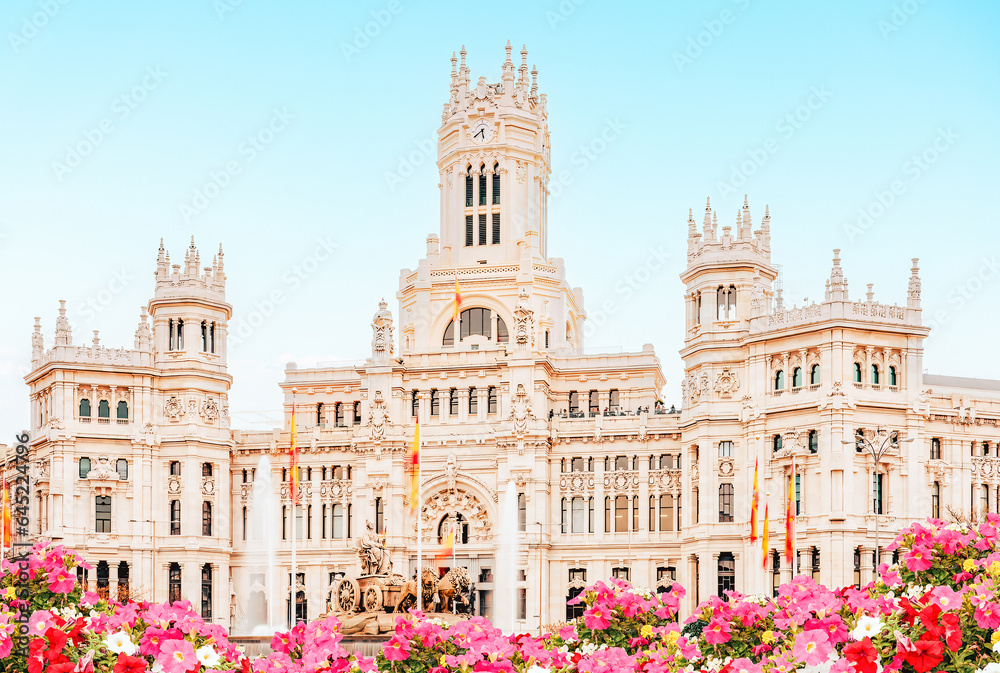 Naklejka premium Spain, Madrid - Madrid City Hall building on Cibeles Square, flower garden in the foreground.