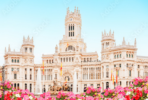 Spain, Madrid - Madrid City Hall building on Cibeles Square, flower garden in the foreground.