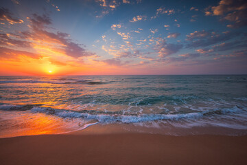 Beautiful cloudscape over tropical sea and beach shore, sunrise over ocean horizon