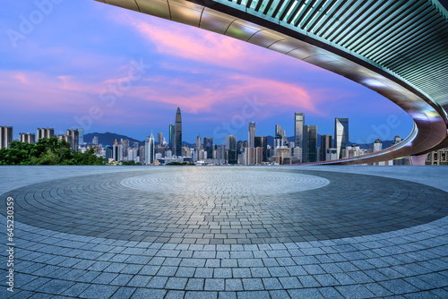 Round square floor and city skyline with modern buildings in Shenzhen at sunset, Guangdong Province, China.