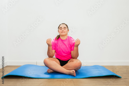 Teenager does yoga exercises at home