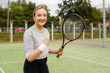 Portrait of young woman professional female tennis player in uniform celebrating a victory.