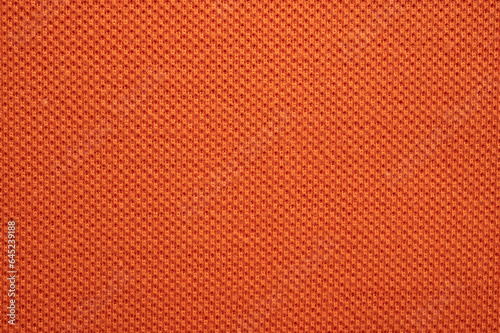Full frame shot of orange polyester fabric texture and background.