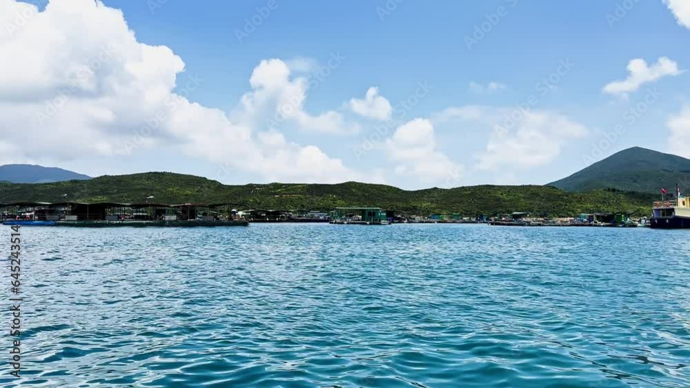 Fishing Village Floating on Sea Viewed from a Boat in a Tropical Island Fishing Village Floating on Sea Viewed from a Boat in a Tropical Island