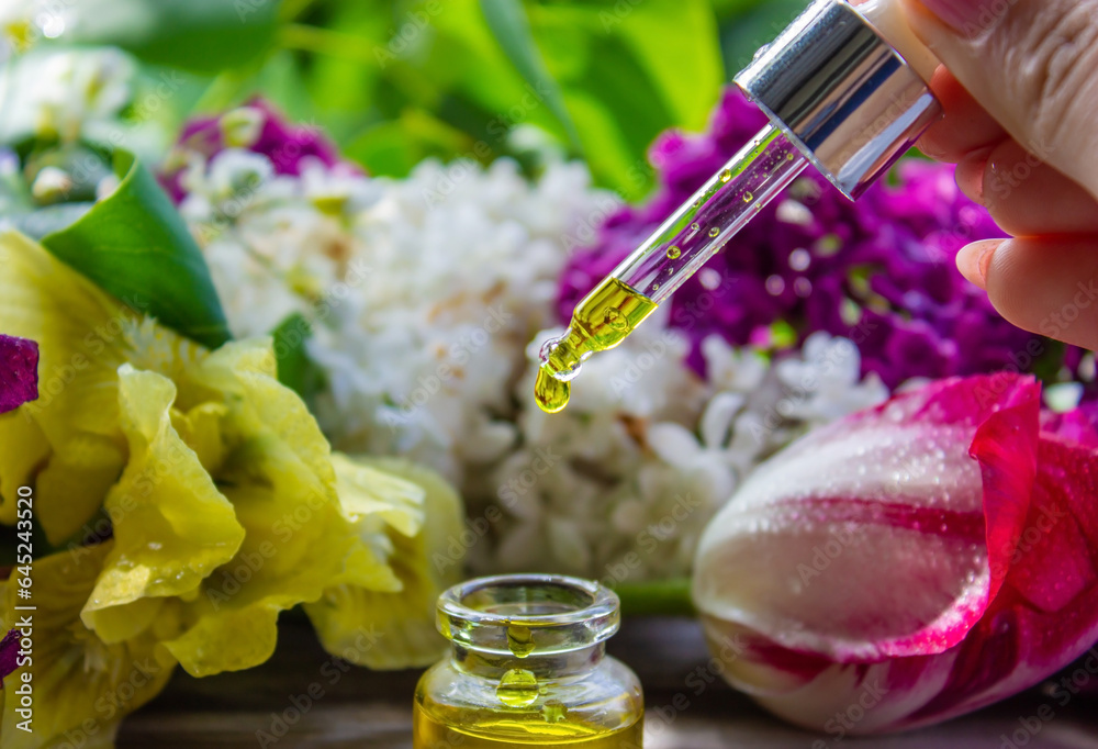 Essential oil extract of herbs and flowers. Selective focus Essential oil extract of herbs and flowers. Selective focus