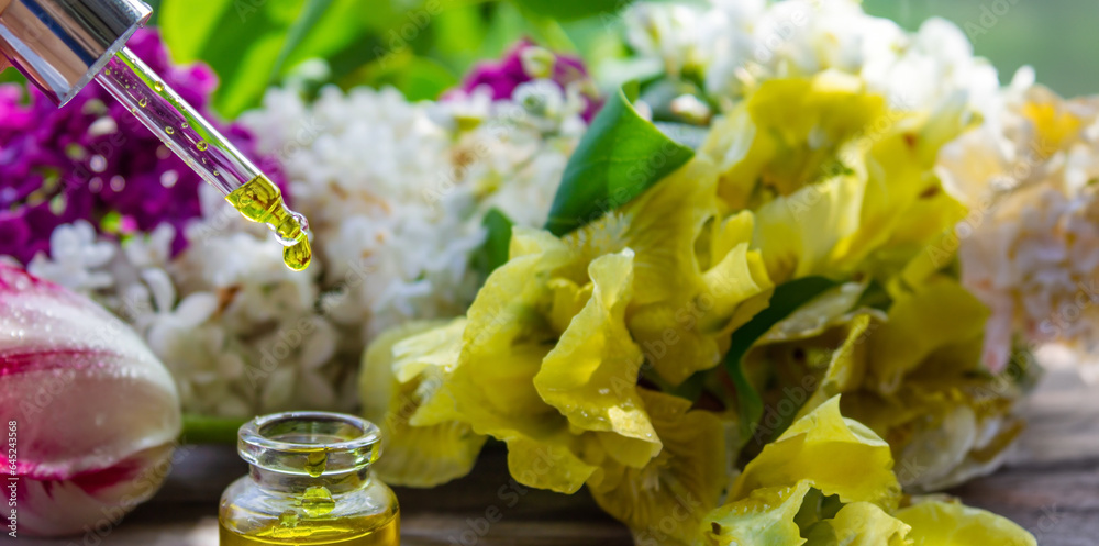 Essential oil extract of herbs and flowers. Selective focus Essential oil extract of herbs and flowers. Selective focus