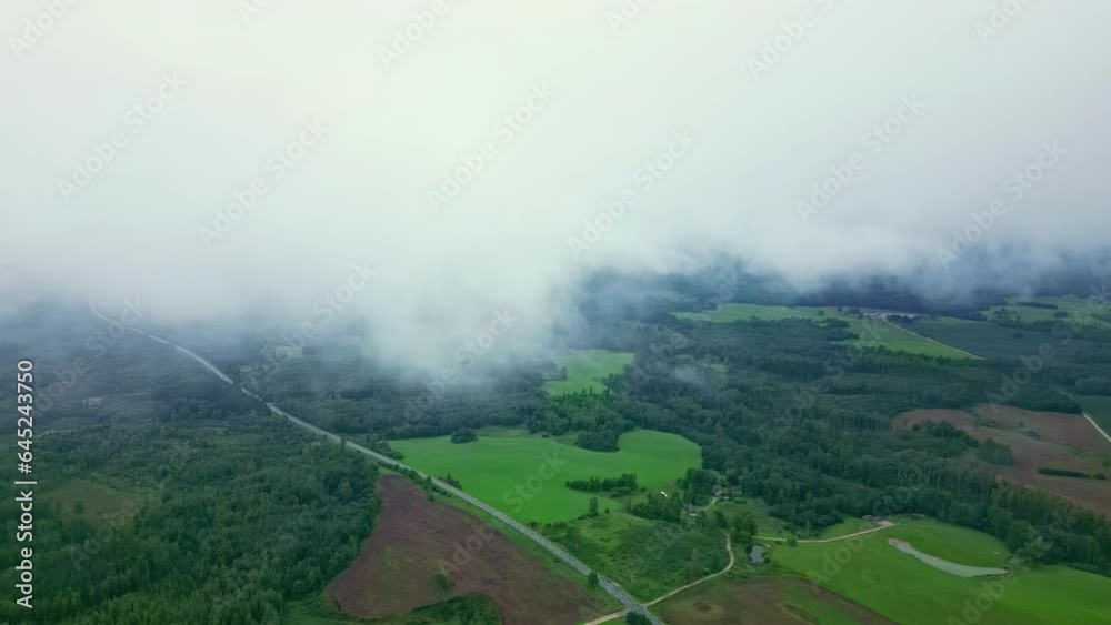 Aerial View Through the Thick Clouds Over Countryside Landscape of Latvia. Aerial View Through the Thick Clouds Over Countryside Landscape of Latvia.