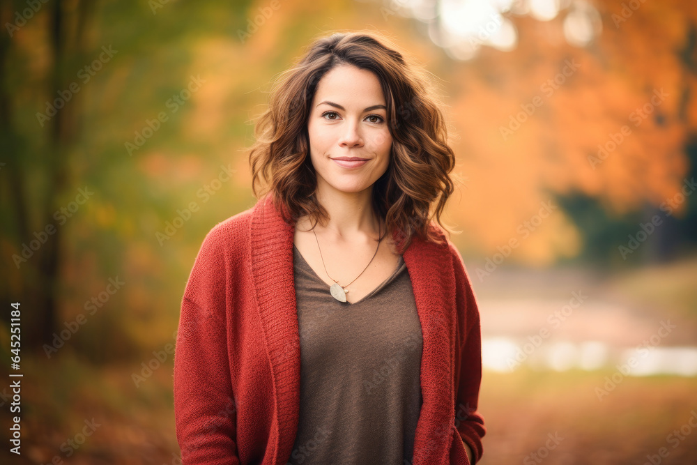 Portrait in the forest of a pleased 30 years old woman. Joyful woman in an outdoor fall scenery having fun at the autumn season. Portrait in the forest of a pleased 30 years old woman. Joyful woman in an outdoor fall scenery having fun at the autumn season.